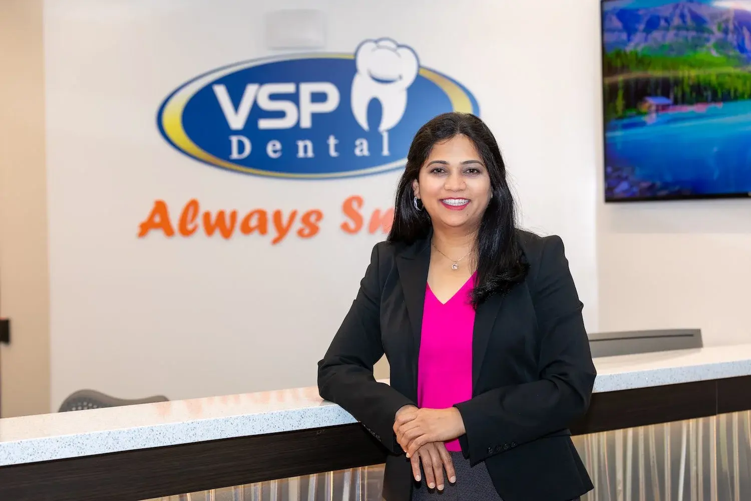 A welcoming VSP Dental team member at the practice reception desk